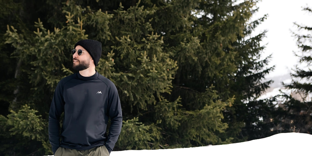 Man standing in snow wearing arctic eco sno ski base layer