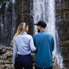 Arctic Eco-Sno Founders wearing Base Layers standing in front of a waterfall.