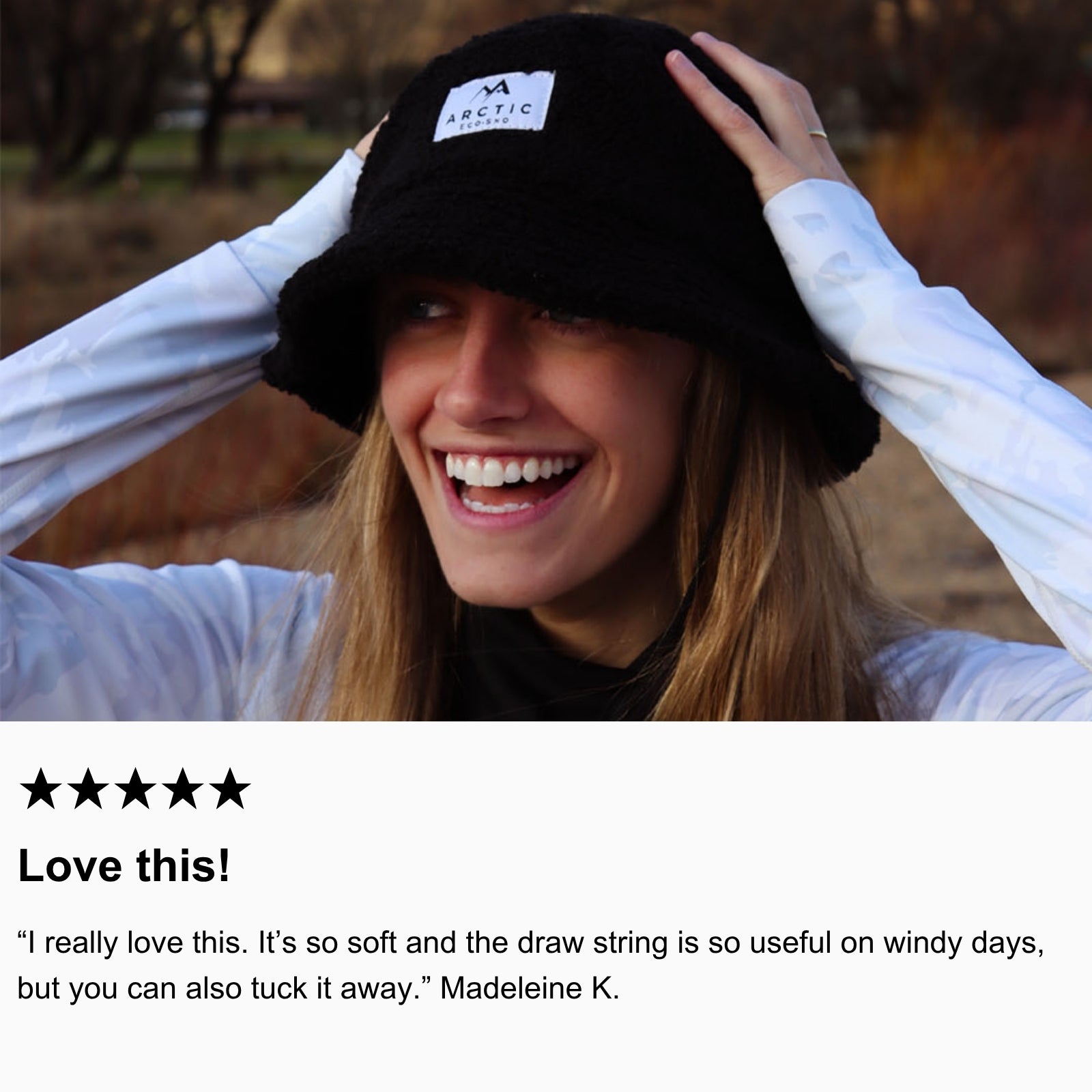 Photo of community member smiling in the mountains, wearing Arctic Eco-Sno’s Bucket Hat and Women’s Base Layers in Sno-Camo.