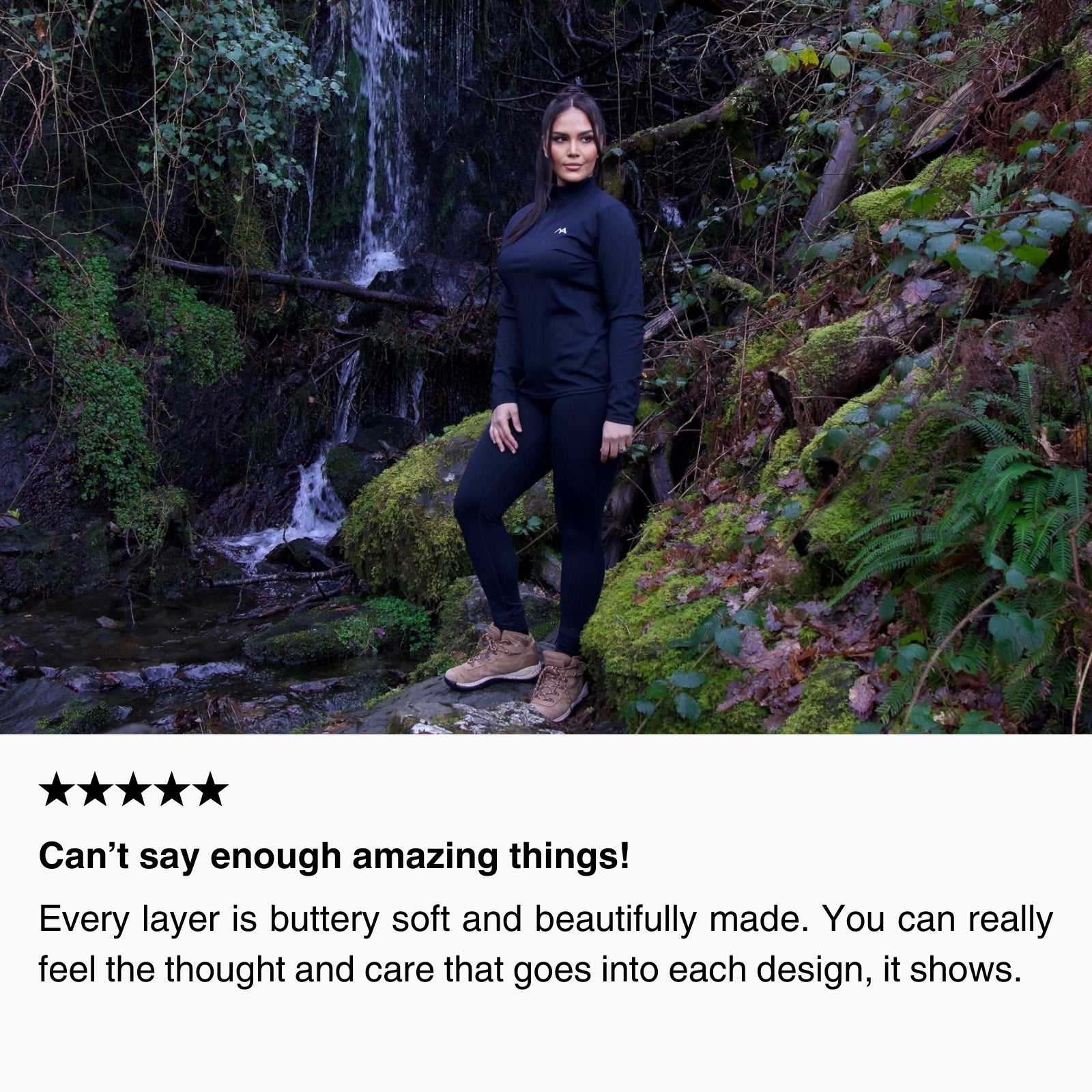 Customer wearing black women’s hiking leggings and thermal base layer standing near a forest waterfall, highlighting buttery-soft fabric, warmth, and durability for outdoor adventures.