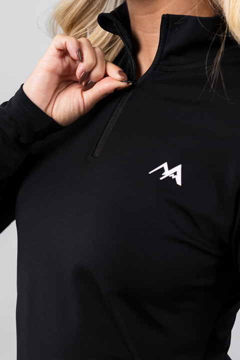 Close-up of the Arctic Eco-Sno women's black thermal base layer top, highlighting the quarter zip, high collar and white chest logo.