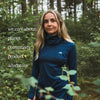 Woman standing in forest wearing Arctic Eco-Sno Women's Base Layer Top in Night Sky Navy.