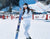 Women holding skis on mountain wearing ski thermals 