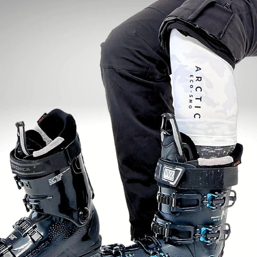 Female wearing snow camo leggings featuring quarter length finish in ski boot.