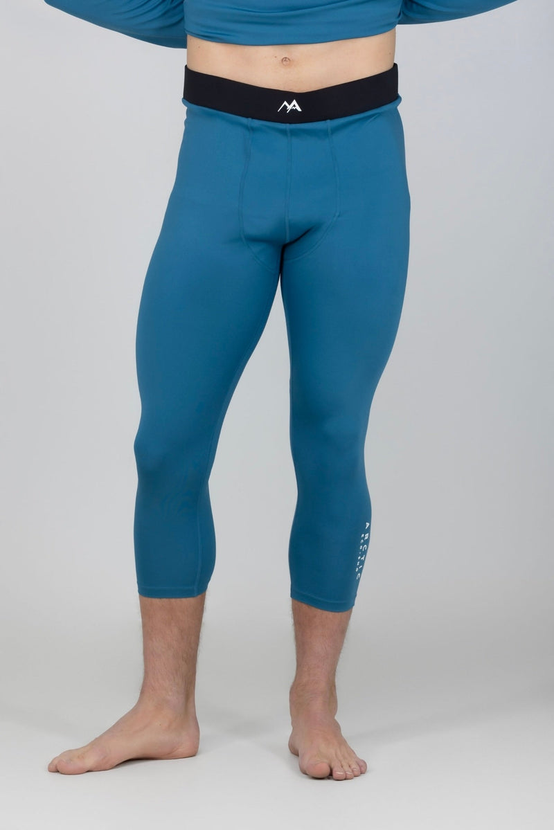 Man wearing blue thermal base layer pant front view.