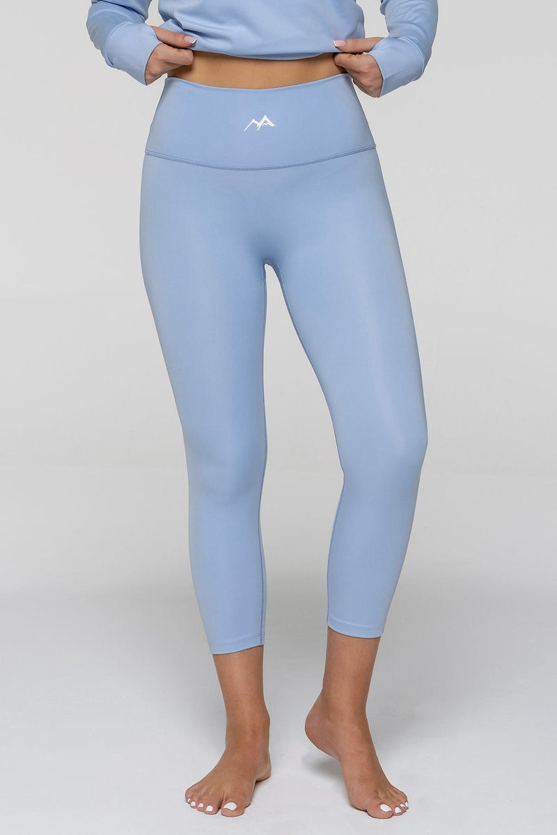 front view of woman wearing WOMEN'S THERMAL BASE LAYER LEGGING SEAMLESS 2.0 SKY BLUE - Arctic Eco - SnoXS