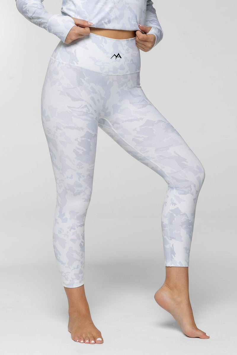 Front view of woman standing in Arctic Eco-Sno Women's Thermal Base Layer Legging Sno-Camo