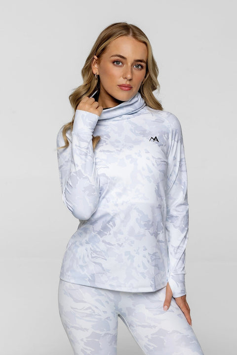 Woman wearing arctic eco sno camo thermal base layer top with grey background.